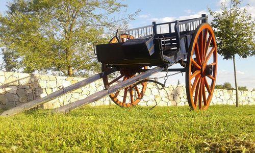 Bicycle on grass against sky