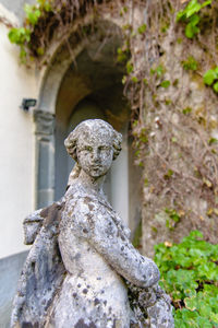 Close-up of statue against stone wall