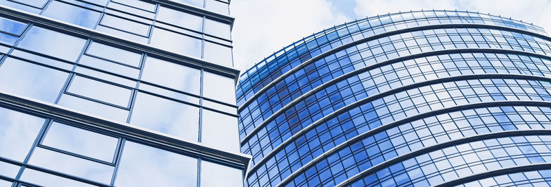 Low angle view of modern building against blue sky