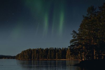 Scenic view of lake against sky at night