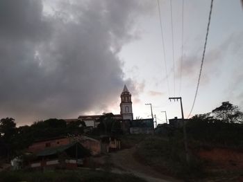 Buildings against cloudy sky at dusk