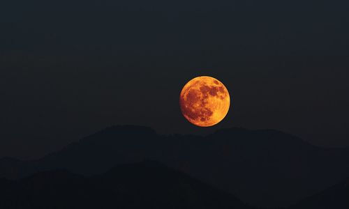 Scenic view of mountains against sky at night