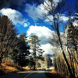 Empty road against cloudy sky