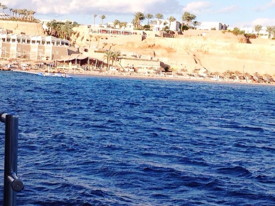 SCENIC VIEW OF SEA BY BUILDINGS AGAINST SKY