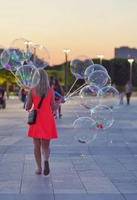 Full length of woman with bubbles in background