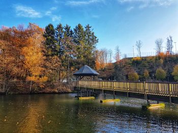 Bridge over river against sky during autumn