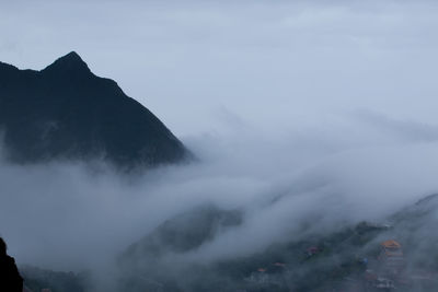 High angle view of houses in foggy valley