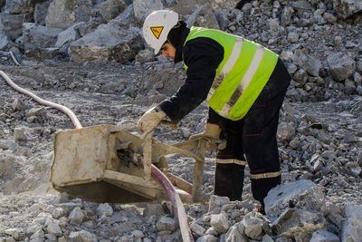 Man working on rock at construction site