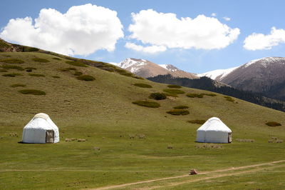 Built structure on countryside landscape against sky