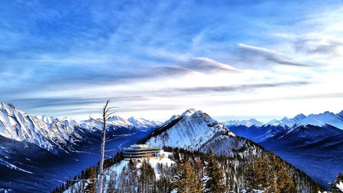 Scenic view of snowcapped mountains against blue sky