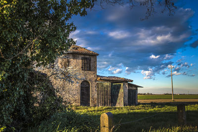 Historic building on field against sky