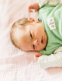 Portrait of cute baby relaxing on bed