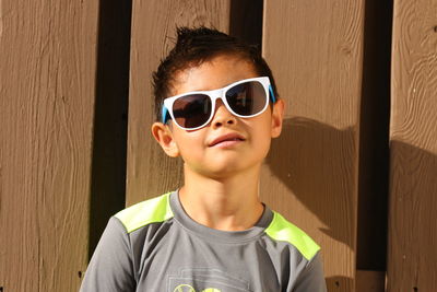 Portrait of boy wearing sunglasses standing outdoors