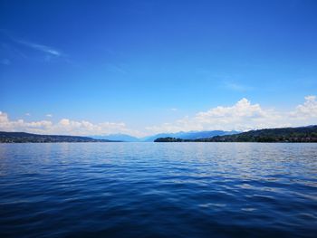 Scenic view of sea against blue sky