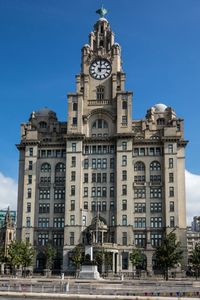 Low angle view of building against blue sky