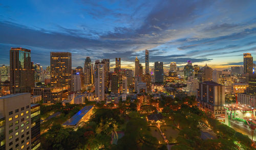 High angle view of illuminated city buildings against sky