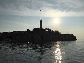 Reflection of buildings in water at sunset