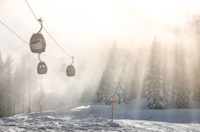 Ski lift over snow covered land