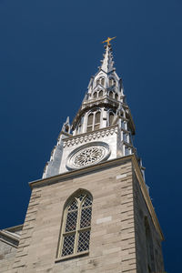 Low angle view of clock tower against clear sky