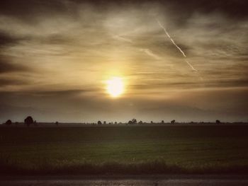 Scenic view of field against sky during sunset