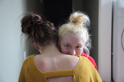 Portrait of mother and daughter at home