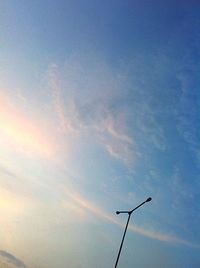 Low angle view of street light against blue sky