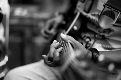 Close-up of woman playing guitar