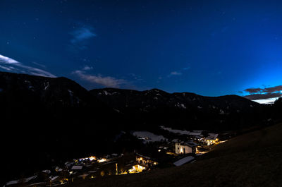 Scenic view of illuminated mountains against sky at night