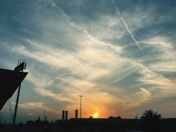 Low angle view of silhouette buildings against sky