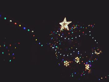 Low angle view of illuminated lights at night