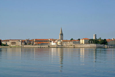 Buildings in city against clear sky