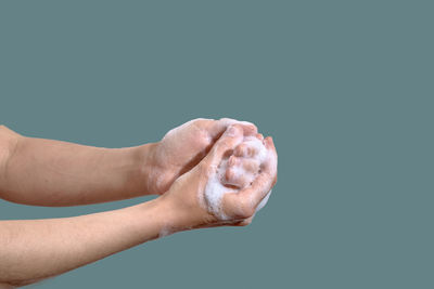 Woman washing hands with soap foam