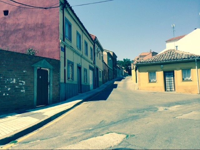 building exterior, architecture, built structure, house, residential structure, residential building, the way forward, street, clear sky, blue, town, window, sunlight, road, building, sky, day, narrow, outdoors, shadow