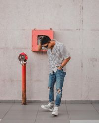 Full length of young man looking at wall