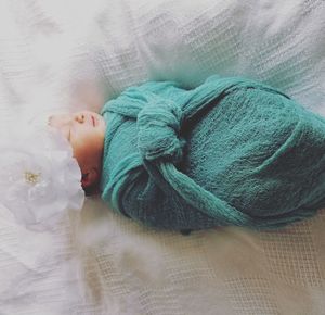 High angle view of baby sleeping on bed at home