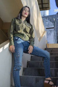 Portrait of woman sitting on staircase