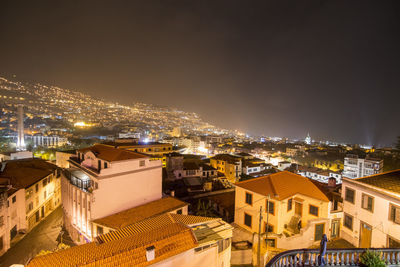 High angle view of illuminated buildings in city at night