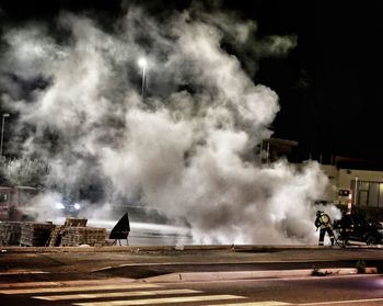 Firefighters at work on street at night