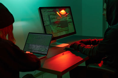 Midsection of woman using laptop on table