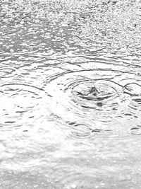 Full frame shot of raindrops on lake