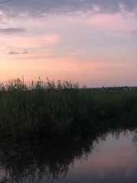 Scenic view of lake against sky during sunset