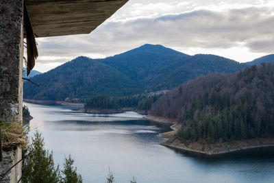 Scenic view of river and mountains against sky