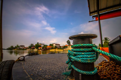 Close-up of rope on street against sky