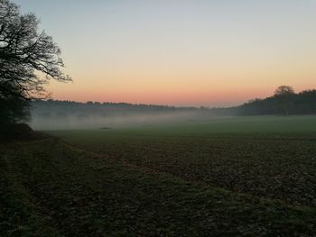 Scenic view of field against sky during sunset