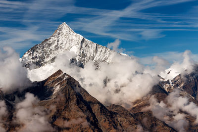 Scenic view of snow covered mountains against sky