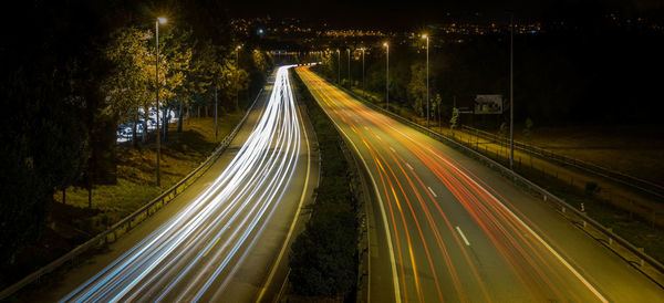 High angle view of light trails on road at night