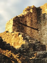 Low angle view of rock formation against sky