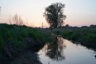 Scenic view of river against sky during sunset