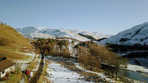 Scenic view of snowcapped mountains against clear sky