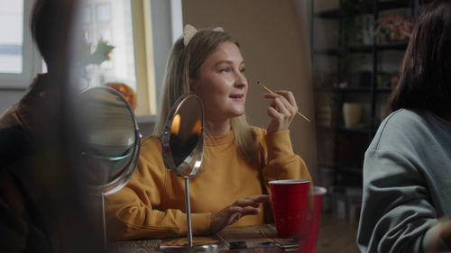 Young woman drinking glass